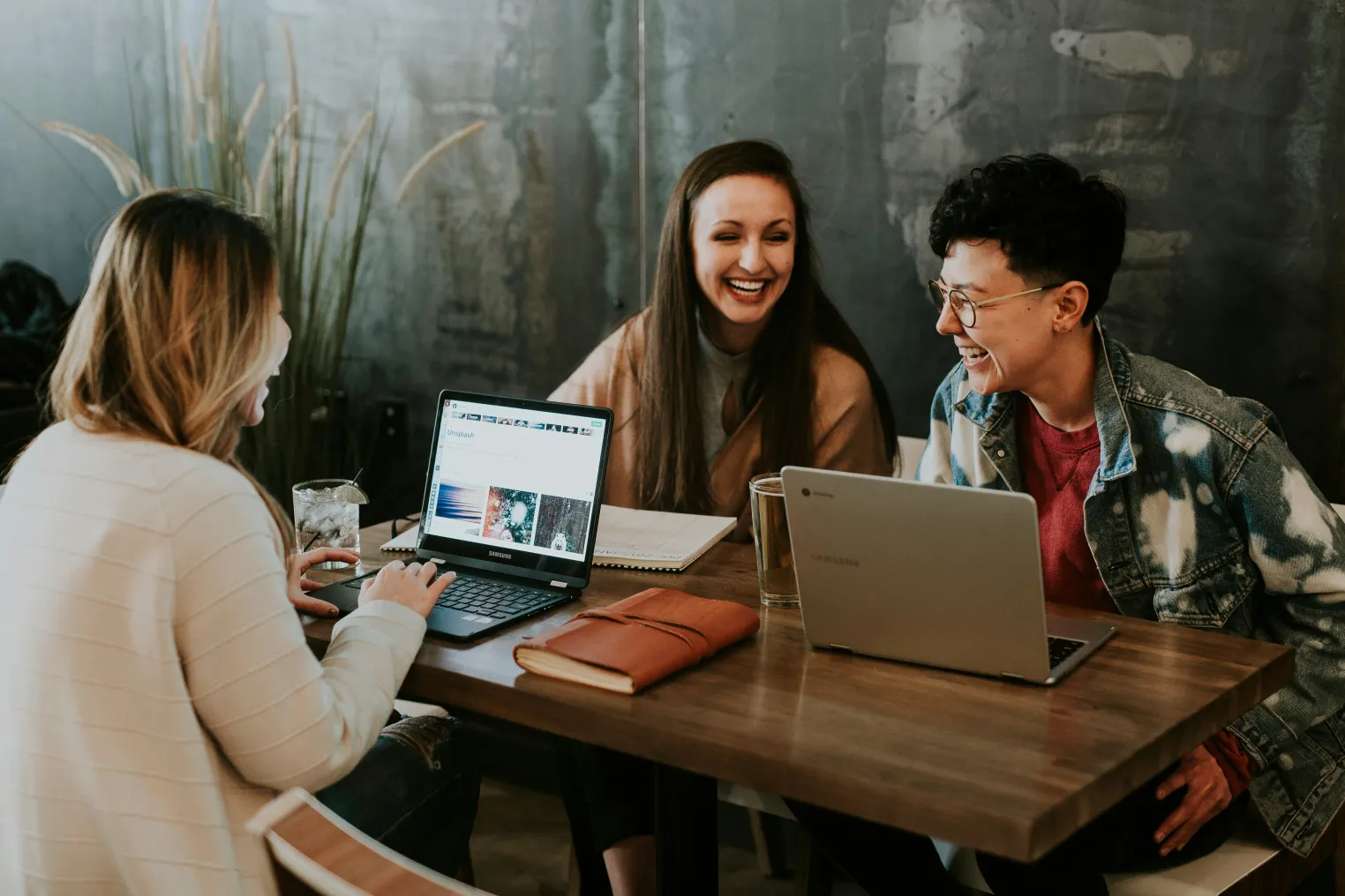 A strategy meeting around a laptop in a modern office